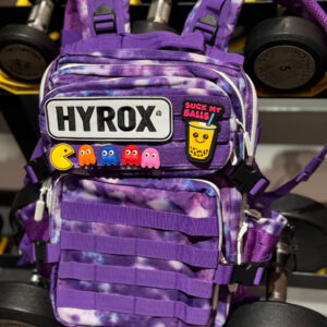 Hyrox backpack purple with example patches on MOLLE patch strip, patches not included