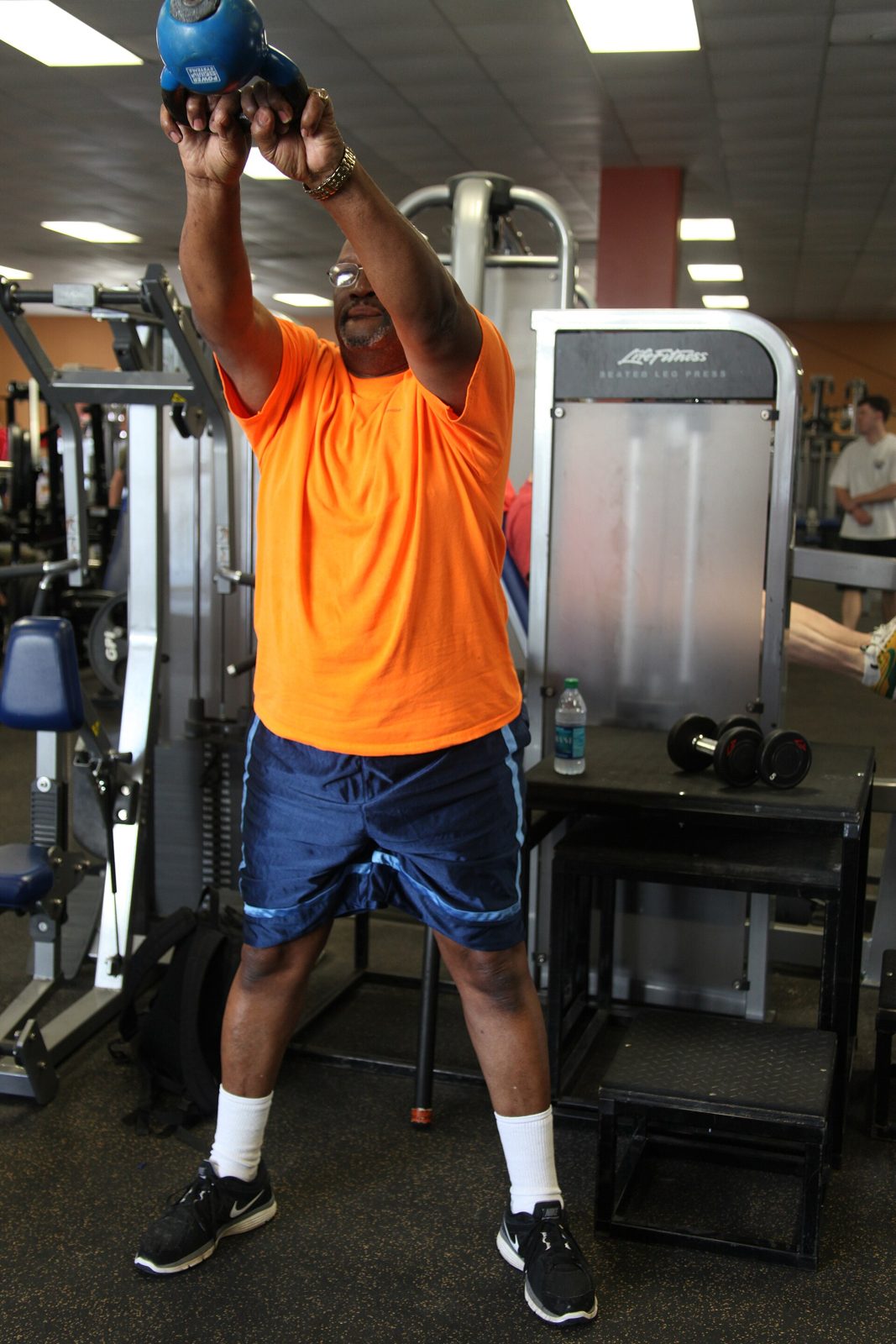 Athlete performing a kettlebell swing, training to HYROX rulebook movement standards