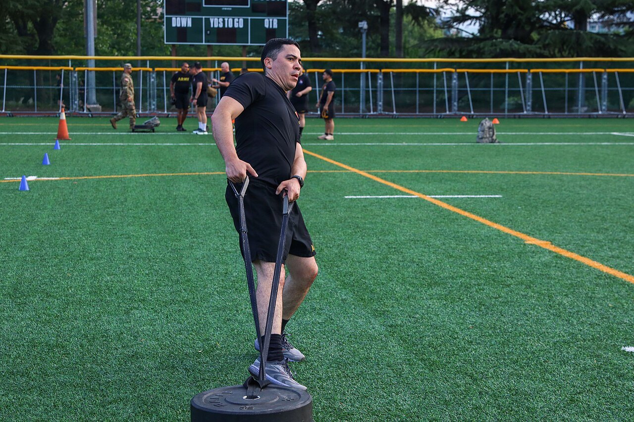 Athlete doing a sled drag in training — testing HYROX shoes on station work