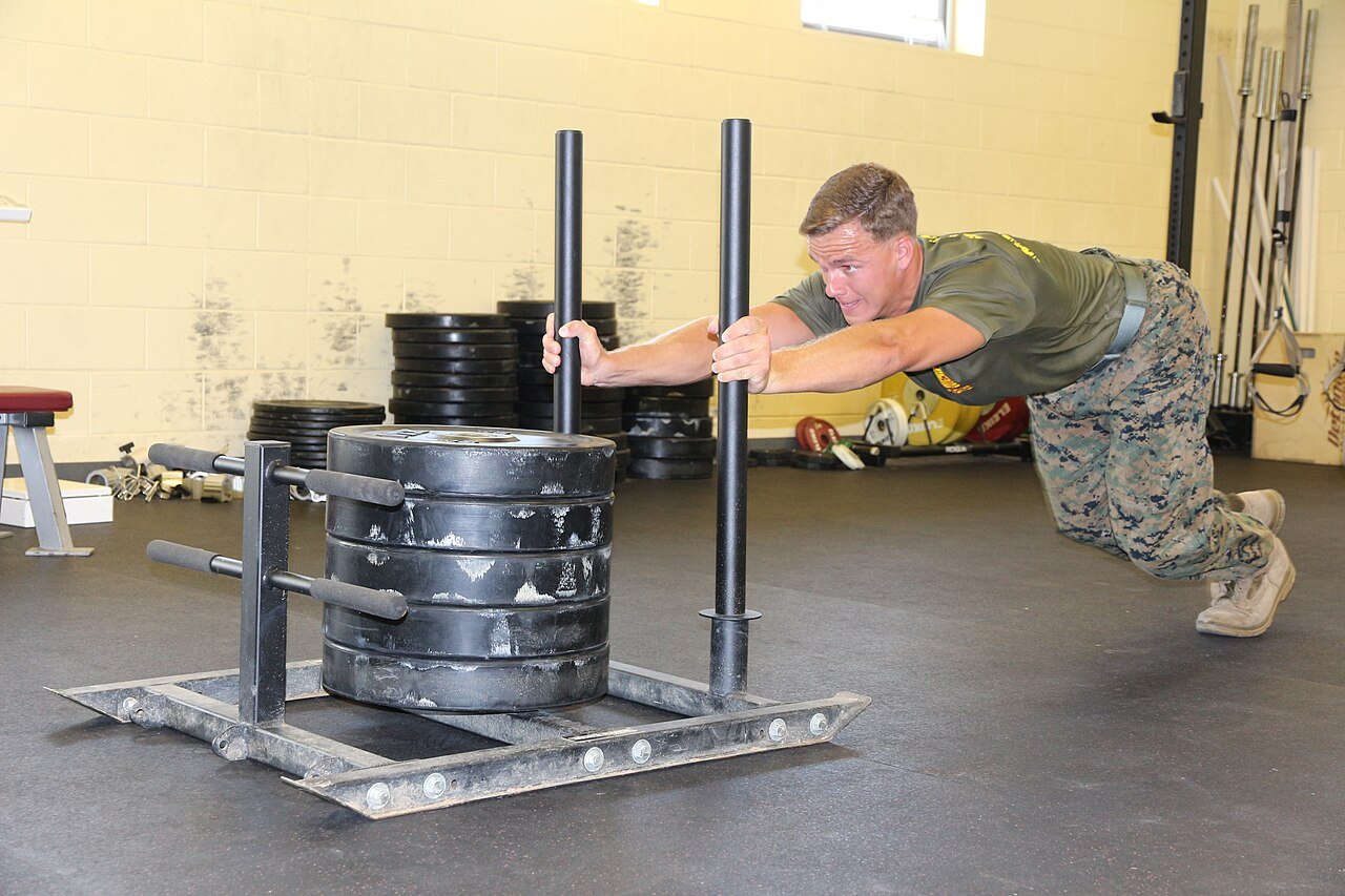 Athlete pushing a weighted sled — sled push splits often decide HYROX Boston results
